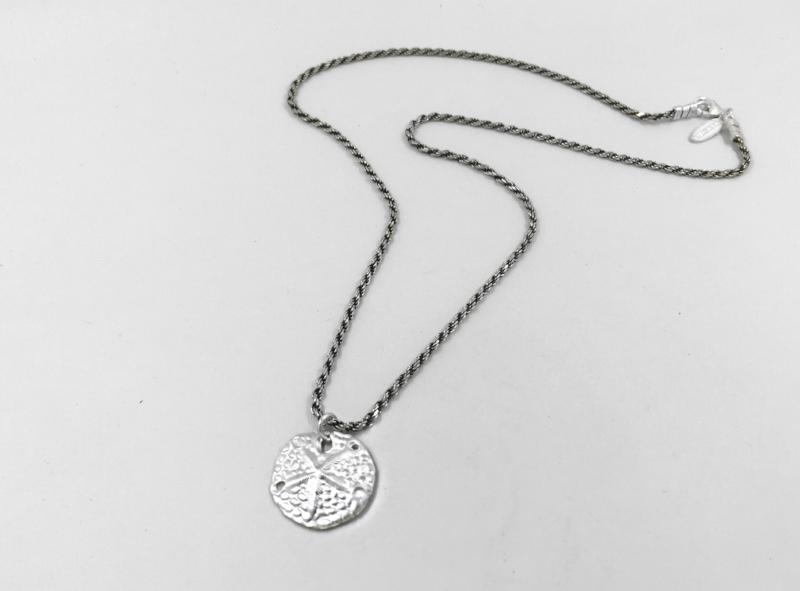 Sand dollar coin on a rope